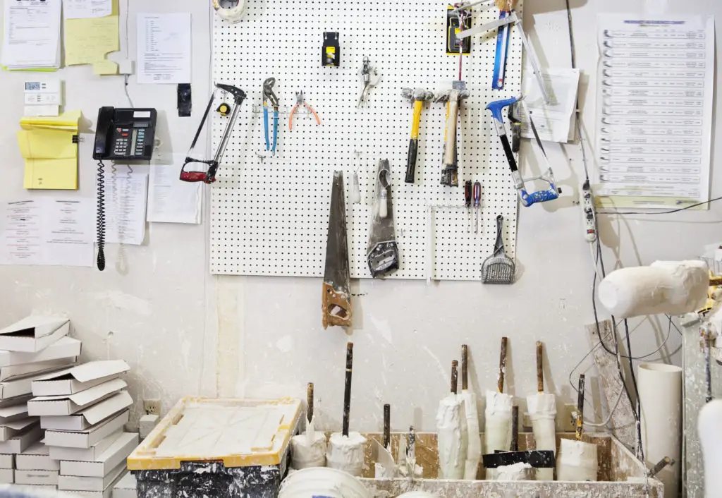 assorted workshop tools on a pegboard